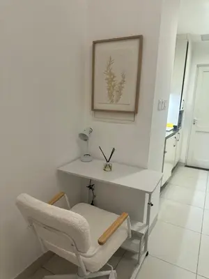 a white desk and a chair in a room at Luxury studio with full sea view in Dubai