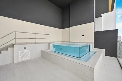 a bathroom with a large blue tub in a room at Golden Stays - Private Pool in Binghatti Onyx I Modern 2BR Apartment I JVC Dubai in Dubai