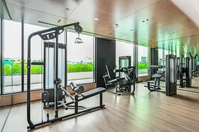a gym with several treadmills and elliptical machines at Golden Stays - Private Pool in Binghatti Onyx I Modern 2BR Apartment I JVC Dubai in Dubai