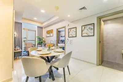 a dining room with a table and chairs at Steps from Dubai Water Canal 2BR, Near Safa Park & SZR, Easy Downtown Access, Aykon City 2 Tower C, Business Bay by Deluxe Holiday Homes in Dubai