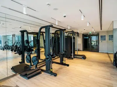 a gym with rows of treadmills and ellipticals at Stunning 1BR Canal Front Residence near Downtown in Dubai