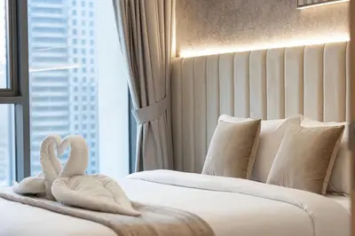 a hotel room with two swans towels on a bed at Burj Khalifa & Fountain Balcony Views, Pool & Gym in Dubai