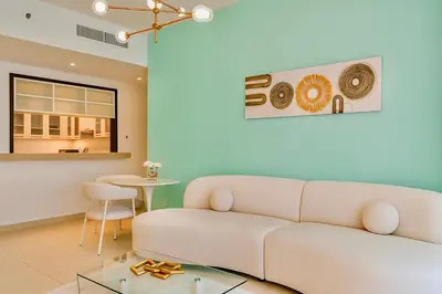 a living room with a couch and a table at Burj View 1BR Pool,Gym,Sauna,Dubai Mall in Dubai