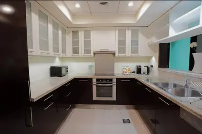 a large kitchen with a sink and a stove at Burj View 1BR Pool,Gym,Sauna,Dubai Mall in Dubai