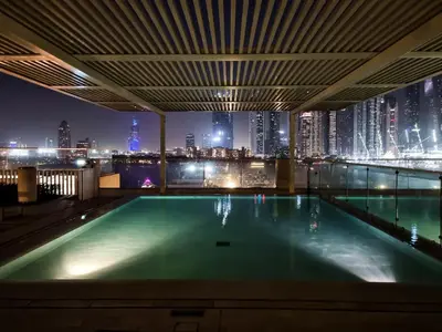 a swimming pool on the roof of a building with a city skyline at Seraya Residences at Marina Vista, Emaar Beachfront in Dubai