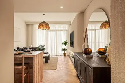 a living room with a couch and a table at Seraya Residences at Marina Vista, Emaar Beachfront in Dubai
