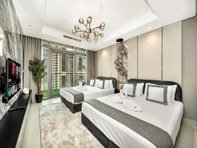 a hotel room with two beds and a flat screen tv at Famous Infinity Pool with Burj Khalifa View on High Floor in Dubai
