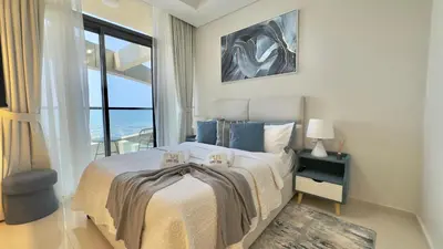 a bedroom with a large bed and a large window at Guest Favorite - 2BR Apartment 57th Floor Close to Downtown in Dubai