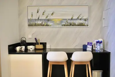 two white chairs sitting at a counter in a room at Guest Favorite - 2BR Apartment 57th Floor Close to Downtown in Dubai