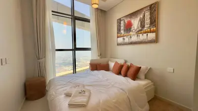 a bedroom with a white bed with a large window at Guest Favorite - 2BR Apartment 57th Floor Close to Downtown in Dubai
