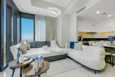a living room with a white couch and tables at Guest Favorite - Premium 3BR with Skyline Views at Floor 50 in Dubai