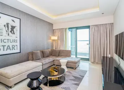 a living room with a couch and a table at Paramount Tower 1 BR, Hollywood Style Stay in Dubai