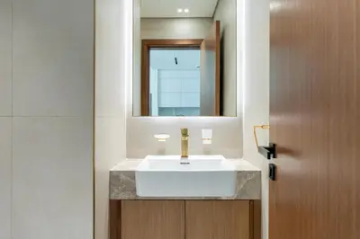 a bathroom with a white sink and a mirror at GuestReady - New Gem | JVC | Binghatti Gardenia in Dubai