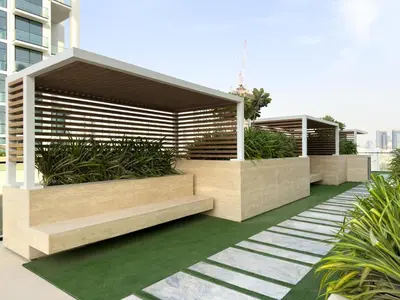 a building with benches and plants on a sidewalk at GuestReady - New Gem | JVC | Binghatti Gardenia in Dubai