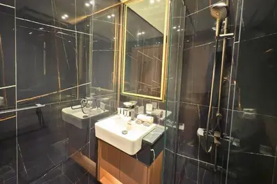 a bathroom with two sinks and a mirror at Guest Favorite - Minimalist 1BR Escape with Balcony in the Heart of JVC in Dubai