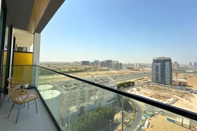 a balcony with a chair and a view of a city at Guest Favorite - Minimalist 1BR Escape with Balcony in the Heart of JVC in Dubai