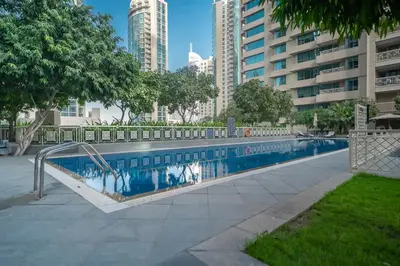 a swimming pool in a city with tall buildings at Guest Favorite - Calm and Classy 1BR on High Floor - Walk to Dubai Mall in Dubai