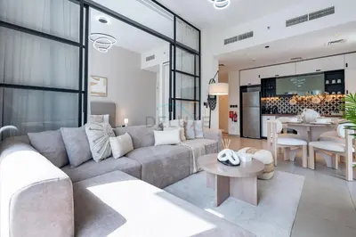 a living room with a couch and a table at Steps from Dubai Hills Mall, Surrounded by Top-Tier Amenities, and close to Dubai Hills Park and Golf Club, Socio Tower 1, Dubai Hills by Deluxe Holiday Homes in Dubai