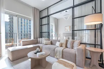 a living room with a couch and a table at Steps from Dubai Hills Mall, Surrounded by Top-Tier Amenities, and close to Dubai Hills Park and Golf Club, Socio Tower 1, Dubai Hills by Deluxe Holiday Homes in Dubai