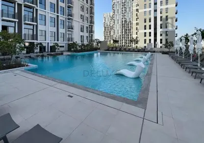 a swimming pool in a city with tall buildings at Steps from Dubai Hills Mall, Surrounded by Top-Tier Amenities, and close to Dubai Hills Park and Golf Club, Socio Tower 1, Dubai Hills by Deluxe Holiday Homes in Dubai