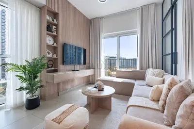 a living room with a couch and a tv at Steps from Dubai Hills Mall, Surrounded by Top-Tier Amenities, and close to Dubai Hills Park and Golf Club, Socio Tower 1, Dubai Hills by Deluxe Holiday Homes in Dubai