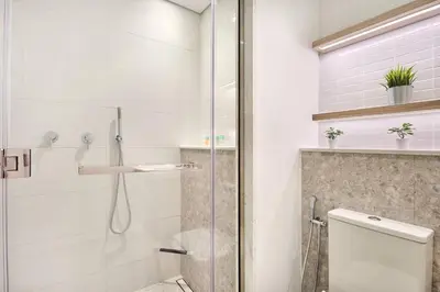 a bathroom with a shower and a toilet at Premium 2BR with Pool, Gym & Lifestyle Amenities in Dubai