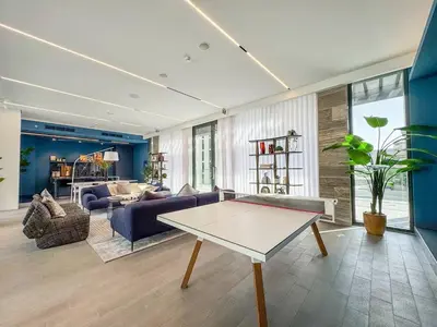 a living room with a couch and a table at Premium 2BR with Pool, Gym & Lifestyle Amenities in Dubai