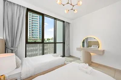 a hotel room with two beds and a large window at Golden Stays - Luxury 2BR I Burj Views & Direct Dubai Mall Access in Dubai