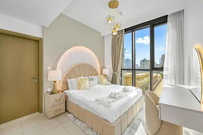 a bedroom with a large bed and a large window at Golden Stays - Luxury 2BR I Burj Views & Direct Dubai Mall Access in Dubai