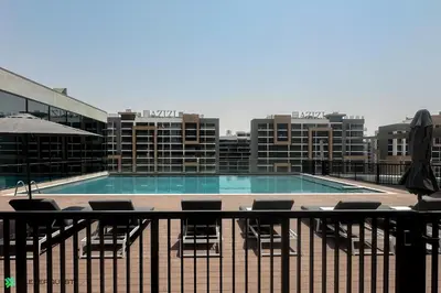 a swimming pool on the roof of a building at Clever Guest 032 Hartland Waves in Dubai