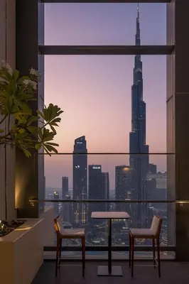 a room with a table and chairs and a view of a city at Downtown Pulse Artful 1BR with Dubai Mall Access by Maxx Value Homes in Dubai