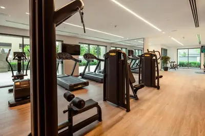 a gym with a row of treadmills and ellipticals at Downtown Pulse Artful 1BR with Dubai Mall Access by Maxx Value Homes in Dubai