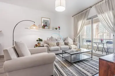 a living room with a couch and a table at Metro-Accessible 2BR, Easy Reach to Marina Mall and JBR Beach, Featuring Stunning SZR & City Views, Marina Diamond 2, Dubai Marina by Deluxe Holiday Homes in Dubai