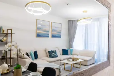 a living room with a white couch and blue pillows at Guest Favorite - Modern and Upgraded 2BR Heart of Downtown in Dubai