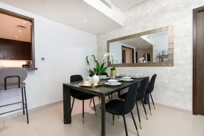 a dining room with a black table and black chairs at Guest Favorite - Modern and Upgraded 2BR Heart of Downtown in Dubai