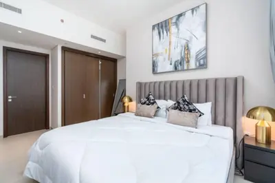 a white bedroom with a large white bed with two pillows at Guest Favorite - Modern and Upgraded 2BR Heart of Downtown in Dubai