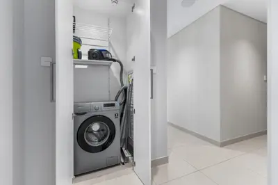 a washer and dryer in a room with a hallway at Guest Favorite - Luxury 2BR with Full Burj Khalifa View Downtown in Dubai