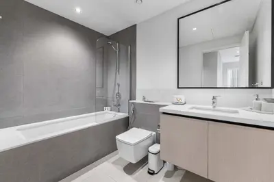 a bathroom with a sink and a toilet and a bath tub at Guest Favorite - Luxury 2BR with Full Burj Khalifa View Downtown in Dubai