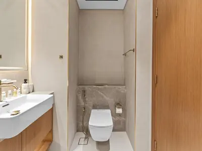 a bathroom with a toilet and a sink at Mesmerizing Canal View Studio in Trillionaire in Dubai
