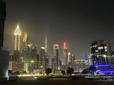 a city skyline at night with lit up buildings at Luxury Hostel Bedspace in Downtown Near Emirates Towers Metro in Dubai