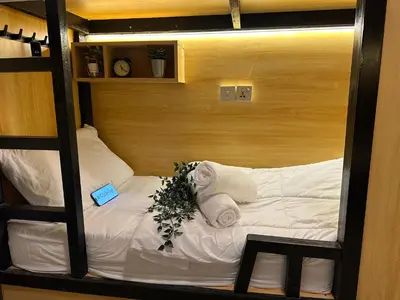 a bunk bed with towels and flowers on it at Luxury Hostel Bedspace in Downtown Near Emirates Towers Metro in Dubai