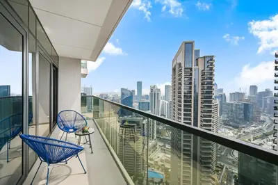 a balcony with chairs and a view of the city at Stylish 2BR Downtown Dubai in Dubai