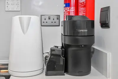 a coffee maker sitting on a counter next to a blender at Stylish 2BR Downtown Dubai in Dubai
