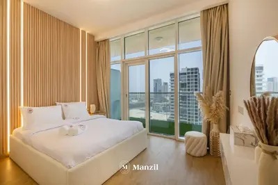 a bedroom with a large bed and a large window at Central 1BHK in JVC w Pool near Dubai Sports City in Dubai