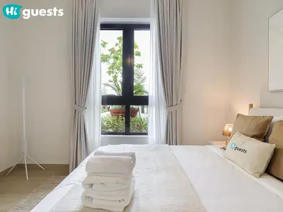a bedroom with a bed with towels on it at HiGuests - Lavish 2BR Apt with Private Beach Access in Dubai