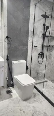 a bathroom with a white toilet and a shower at Opalz by danube science park in Dubai