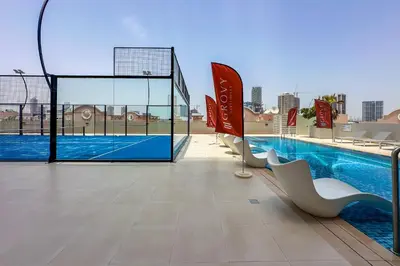 a view of a swimming pool on top of a building at Brand New 1 Bedroom in AURA by Grovy, JVC in Dubai
