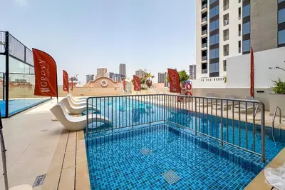 a swimming pool on top of a building at Brand New 1 Bedroom in AURA by Grovy, JVC in Dubai