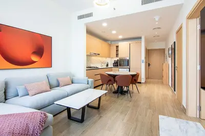 a living room with a couch and a table at Brand New 1 Bedroom in AURA by Grovy, JVC in Dubai
