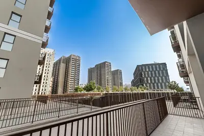 a view of the city from a balcony of a building at Escape 24 Lux 2BR Collective Dubai Hills in Dubai